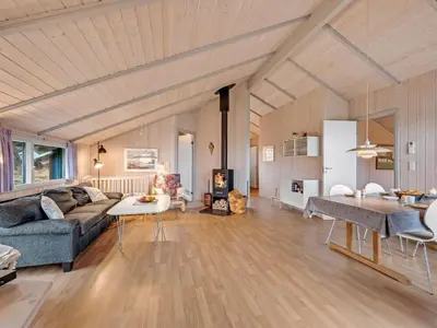 a living room with a couch and a table at Holiday Home Mimo - 150m from the sea by Interhome in Harboør