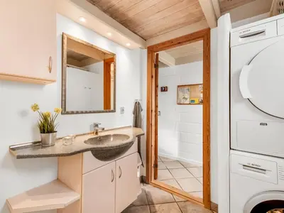 a bathroom with a sink and a mirror at Holiday Home Eringisl - 50m from the sea by Interhome in Harboør