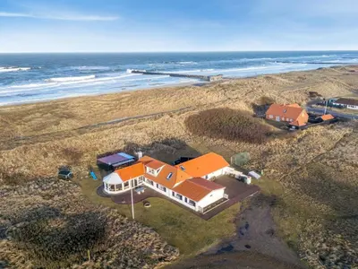 an aerial view of a house next to the ocean at Holiday Home Pauli - 75m from the sea by Interhome in Harboør