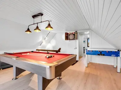 a pool table in a room with a ceiling at Holiday Home Kristanna - 150m from the sea by Interhome in Harboør