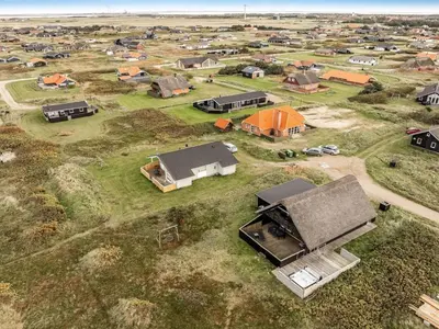 an overhead view of a house in a field at Holiday Home Kristanna - 150m from the sea by Interhome in Harboør
