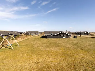 a large yard with houses in the background at Holiday Home Hildegunda - 950m from the sea by Interhome in Harboør