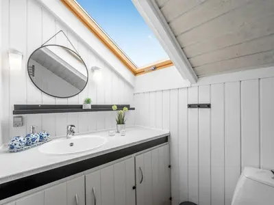 a bathroom with a sink and a mirror at Holiday Home Olesia - 250m from the sea by Interhome in Harboør