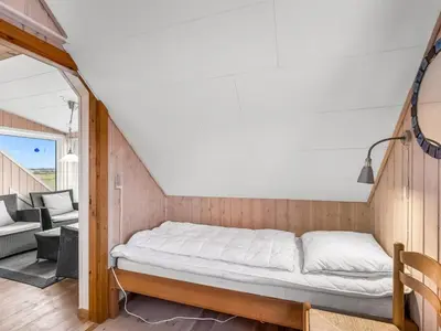 a bed in a room with a patio at Holiday Home Dietlinde - 100m from the sea by Interhome in Harboør