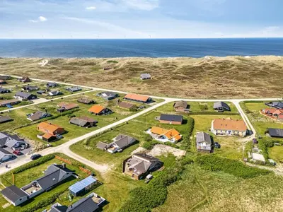 an aerial view of a small house near the ocean at Holiday Home Arla - 200m from the sea by Interhome in Harboør