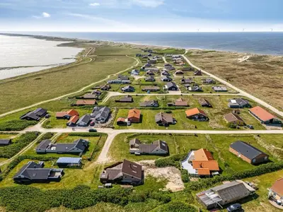 an aerial view of a group of houses on the beach at Holiday Home Arla - 200m from the sea by Interhome in Harboør