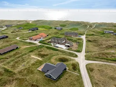 an aerial view of a house on the ocean at Holiday Home Filip - 100m from the sea by Interhome in Harboør