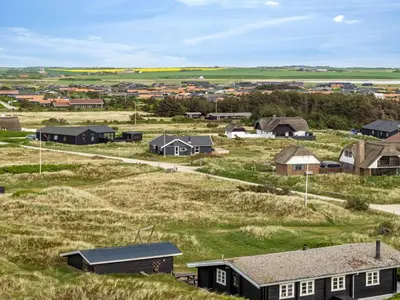 a small village with houses in a field at Holiday Home Filip - 100m from the sea by Interhome in Harboør