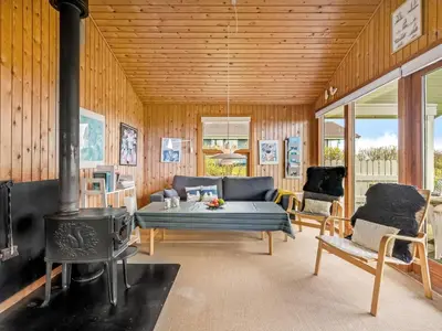 a living room with a couch and a stove at Holiday Home Tanea - 700m to the fjord by Interhome in Lemvig