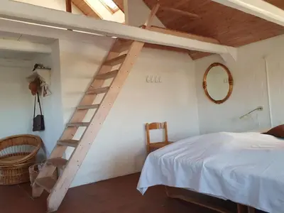 a bedroom with a ladder and a bed and a mirror at Holiday Home Answald - 250m from the sea by Interhome in Harboør