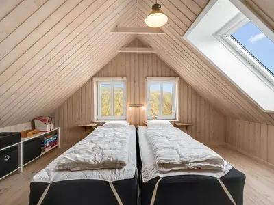 a bedroom with two beds in a attic at Holiday Home Ali - 75m from the sea by Interhome in Harboør