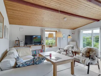 a living room with a couch and a table at Holiday Home Suki - 650m from the sea by Interhome in Torsted