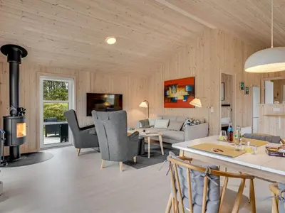 a living room with a couch and a table at Holiday Home Gyrial - 950m from the sea by Interhome in Torsted