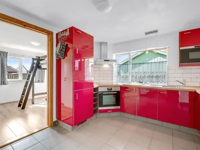 a kitchen with red cabinets and a red refrigerator at Holiday Home Heming - 100m from the sea by Interhome in Thyborøn