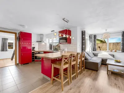 a kitchen and living room with red cabinets at Holiday Home Heming - 100m from the sea by Interhome in Thyborøn