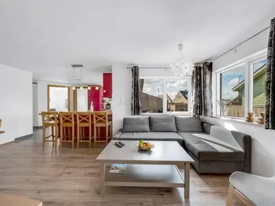 a living room with a couch and a table at Holiday Home Heming - 100m from the sea by Interhome in Thyborøn