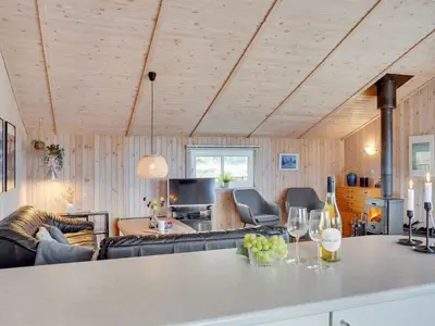 a living room with a couch and a table with wine glasses at Holiday Home Melanie - 950m from the sea by Interhome in Torsted