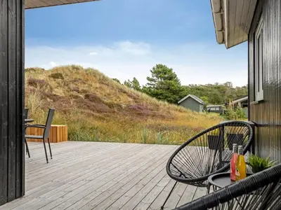 a patio with two chairs and a table on a deck at Holiday Home Melanie - 950m from the sea by Interhome in Torsted
