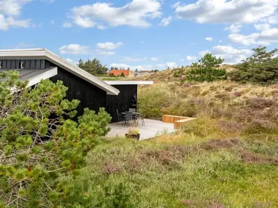 a house on a hillside with a wooden building at Holiday Home Melanie - 950m from the sea by Interhome in Torsted