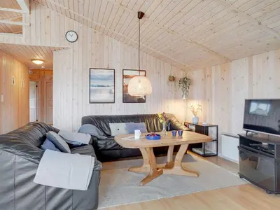 a living room with a couch and a table at Holiday Home Melanie - 950m from the sea by Interhome in Torsted