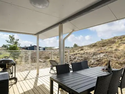a patio with a table and chairs and a grill at Holiday Home Ibo - 900m from the sea by Interhome in Torsted