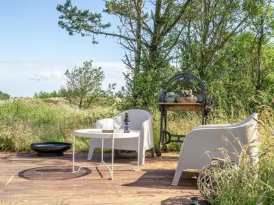 a patio with a white table and two chairs at Holiday Home Aurelie - 800m from the sea by Interhome in Torsted
