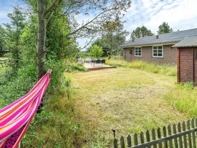a hammock in the yard of a house at Holiday Home Aurelie - 800m from the sea by Interhome in Torsted