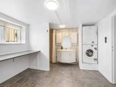 a laundry room with a washer and dryer at Holiday Home Eluisa - 300m from the sea by Interhome in Thyborøn