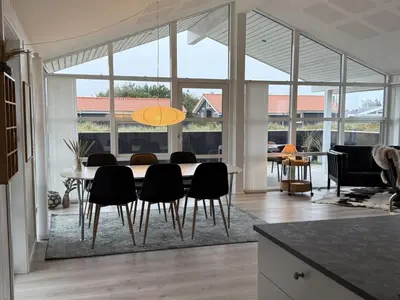 a dining room with a table and some chairs at Holiday Home Mauri - 350m from the sea by Interhome in Torsted