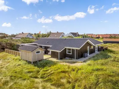 a row of houses on a grassy field at Holiday Home Mauri - 350m from the sea by Interhome in Torsted