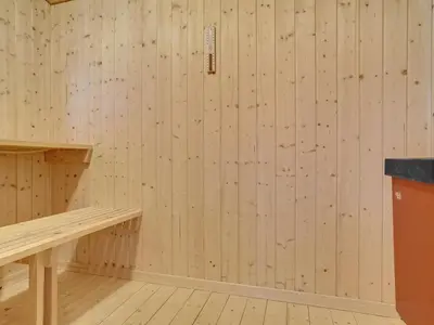 a room with wooden walls and a wooden bench at Holiday Home Jerg - 500m from the sea by Interhome in Torsted