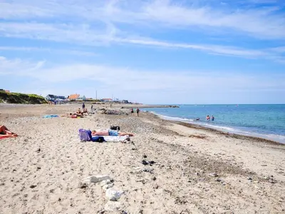a group of people laying on a beach at Holiday Home Styrmer - 1-2km from the sea by Interhome in Torsted