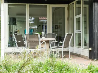 a patio with chairs and a table on a house at Holiday Home Henkil - 700m from the sea by Interhome in Torsted