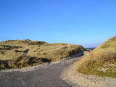 a dirt road on the side of a hill at Holiday Home Usko - 250m from the sea by Interhome in Torsted