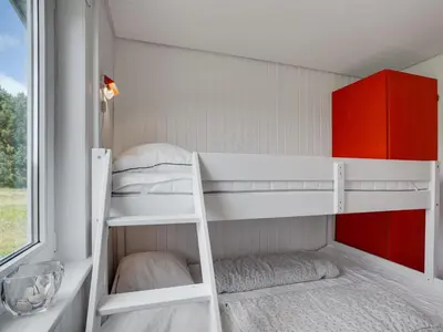 a small room with two bunk beds and a window at Holiday Home Usko - 250m from the sea by Interhome in Torsted
