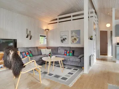 a living room with a couch and a table at Holiday Home Alethe - 1km from the sea by Interhome in Torsted