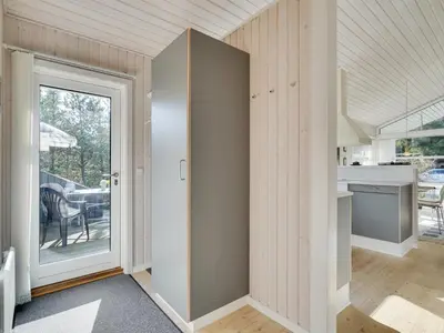 a kitchen with a door leading to a patio at Holiday Home Alethe - 1km from the sea by Interhome in Torsted