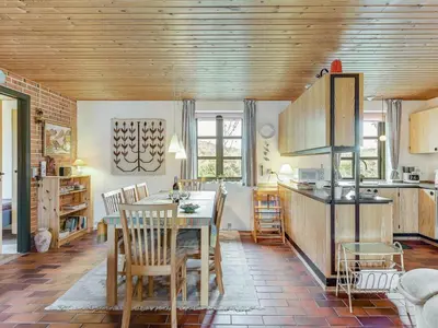 a kitchen with a table and chairs in a room at Holiday Home Thermet - 900m from the sea by Interhome in Torsted