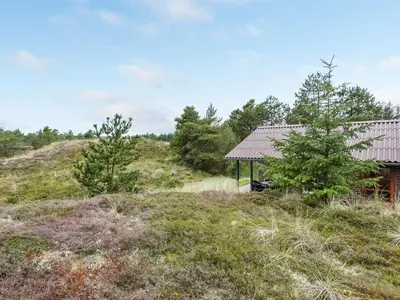 a house on top of a hill with trees at Holiday Home Thermet - 900m from the sea by Interhome in Torsted
