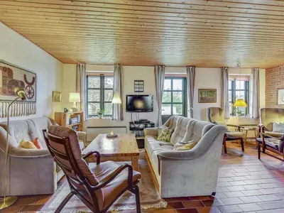 a living room with couches and chairs and a tv at Holiday Home Thermet - 900m from the sea by Interhome in Torsted