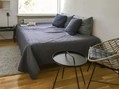 a bedroom with a bed with a table and a chair at Holiday Home Flor - 900m from the sea by Interhome in Torsted
