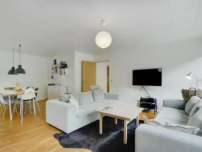 a living room with a couch and a table at Holiday Home Flor - 900m from the sea by Interhome in Torsted