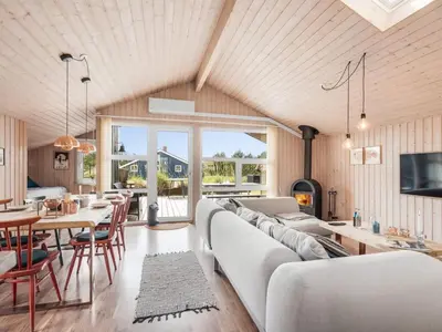 a living room with a white couch and a table at Holiday Home Suleika - 900m from the sea by Interhome in Torsted