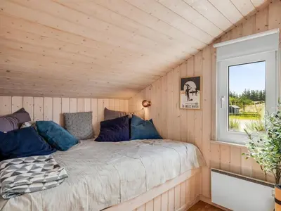 a bed in a room with a window at Holiday Home Suleika - 900m from the sea by Interhome in Torsted