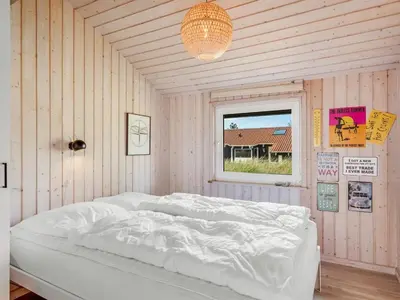 a white bed in a room with a window at Holiday Home Suleika - 900m from the sea by Interhome in Torsted