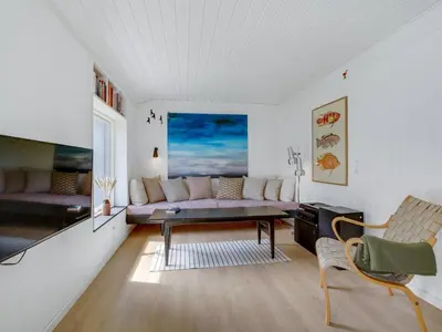 a living room with a couch and a table at Holiday Home Fidelia - 800m from the sea by Interhome in Torsted