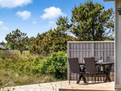 a patio with a table and chairs on a deck at Holiday Home Tayanita - 750m from the sea by Interhome in Torsted
