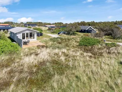 a house on top of a grassy field at Holiday Home Tayanita - 750m from the sea by Interhome in Torsted