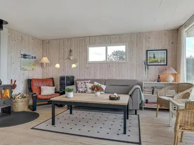 a living room with a couch and a table at Holiday Home Tayanita - 750m from the sea by Interhome in Torsted