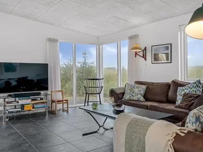 a living room with a couch and a tv at Holiday Home Pontus - 400m from the sea by Interhome in Torsted